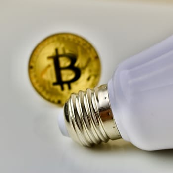 Bitcoin cryptocurrency and white big bulb
