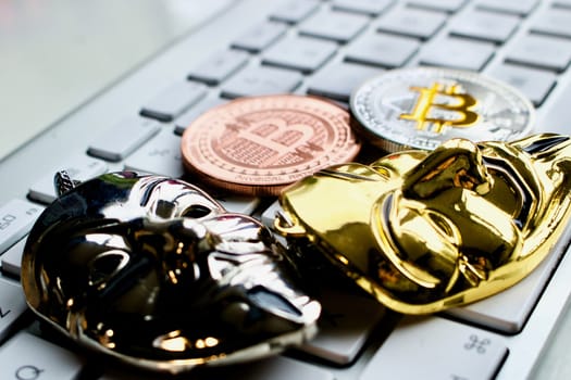 Cryptocurrency physical brass and silver bitcoin on the keyboard