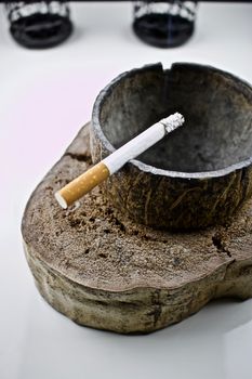 Cigarette in coconut handmade ashtray