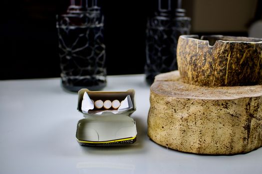 Box of cigarettes and coconut handmade ashtray