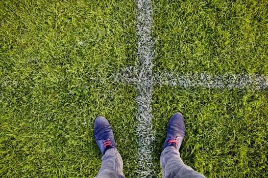 Legs between white lines on the grass
