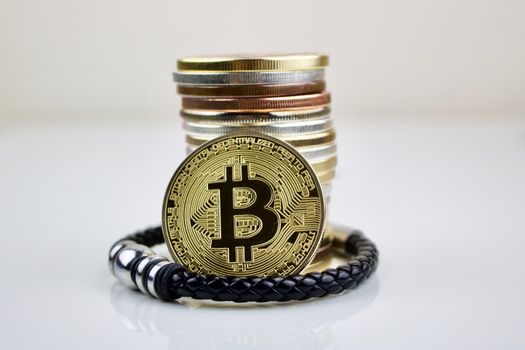 Cryptocurrency physical coin and mans bracelet