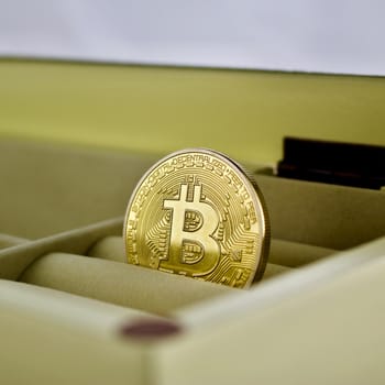 Gold bitcoin cryptocurrency in a yellow box