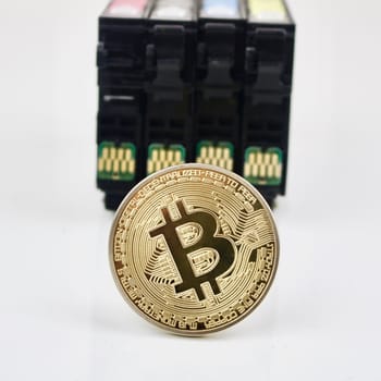 Bitcoin cryptocurrency gold coin and print cardridges