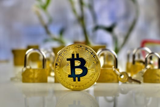 Cryptocurrency physical gold bitcoin coin near gold padlocks