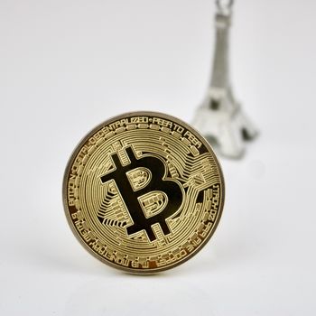 Gold bitcoin cryptocurrency coin and silver tower