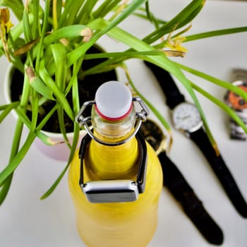 Old yellow bottle watch holder, flower, clocks