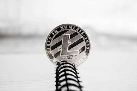 Digital currency physical silver litecoin coin. Cryptocurrency concept.