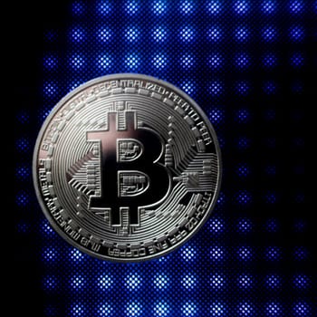 Cryptocurrency silver bitcoin on the blue light pattern