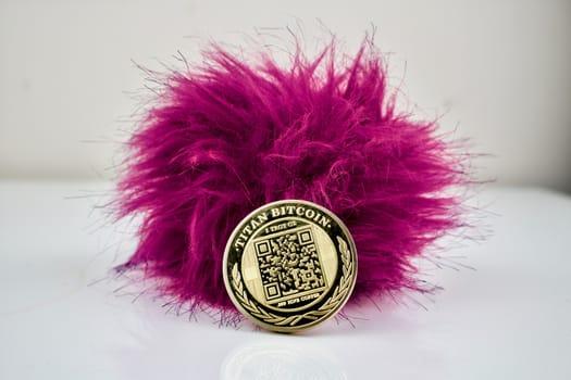 Hairy pink ball and one gold titan bitcoin cryptocurrency