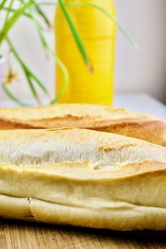 Fresh bread, bottle and flower - kitchen composition.