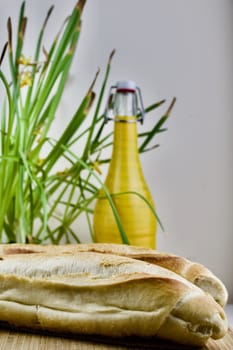 Green flower, fresh rolls and yellow old bottle
