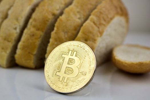 Fresh bread and gold bitcoin cryptocurrency coin.