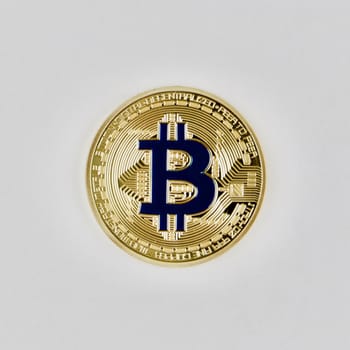 Digital currency physical gold bitcoin coin with a blue sign