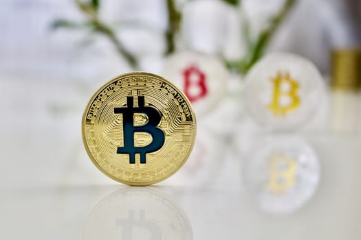 Cryptocurrency physical colored bitcoin coins. Pink bitcoin, blue bitcoin and yellow bitcoin