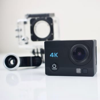 Black small sport camera 4K with equipment.