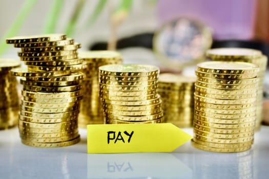 Gold coins concept and pay yellow arrow