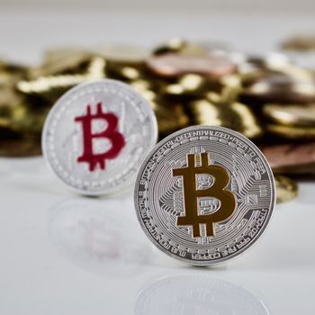 Cryptocurrency physical silver bitcoin coins near other gold money