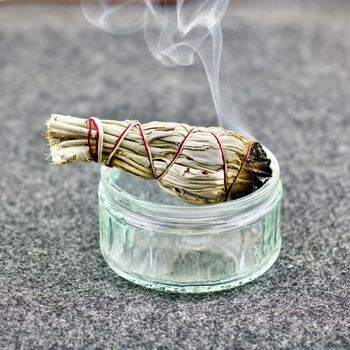 White salvia burning in glass jar