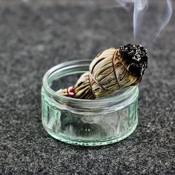 White salvia chives burns in a glass