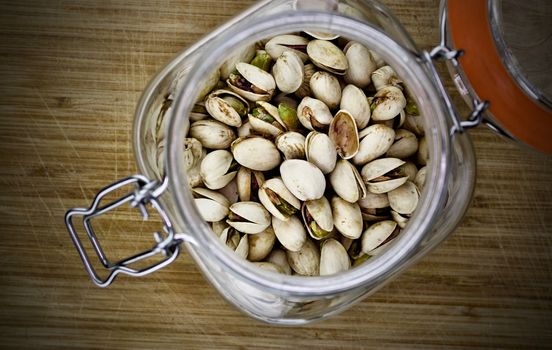 Fresh pistachios in big glass kitchen jar