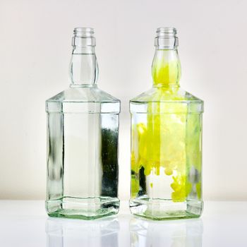 Two bottles on the table and yellow colour effect