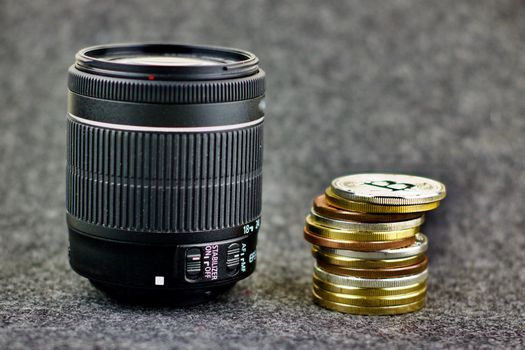 Cryptocurrency gold money and dslr camera lens