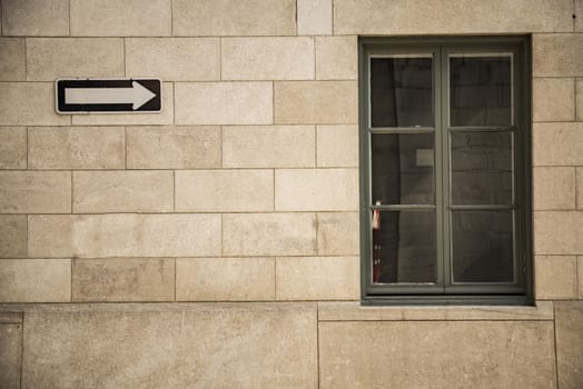 Red brick wall with a windowand raod sign in Canada