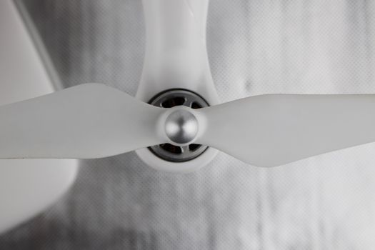 White long airscrew on the white quadcopter with silver engine.