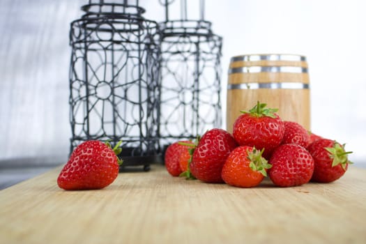 Fresh red big strawberries in kitchen on the wooden board.