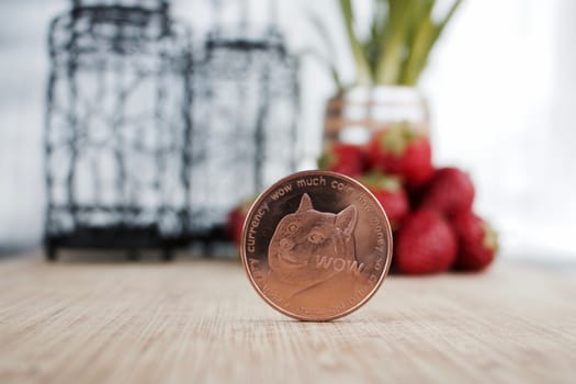 Digital currency brass doge coin and strawberry.