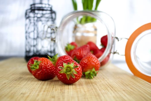 Red and fresh strawberries from jar in the kitchen. Fruit concept