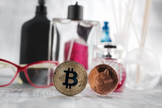 Digital currency physical gold bitcoin and brass dogecoin in perfume composition