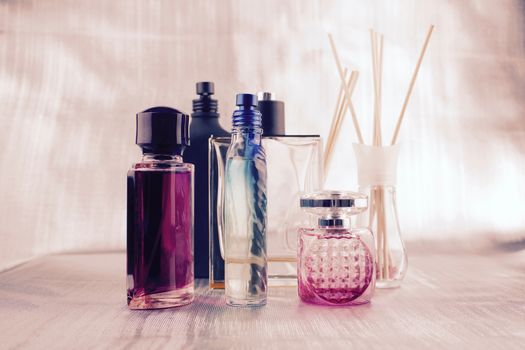 Bottles with a fragrances. Pink composition on the table