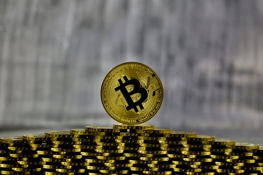 Cryptocurrency physical gold bitcoin coin on the gold money tower.