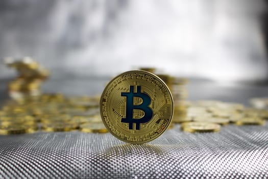 Digital currency physical gold bitcoin coin with a blue sign.
