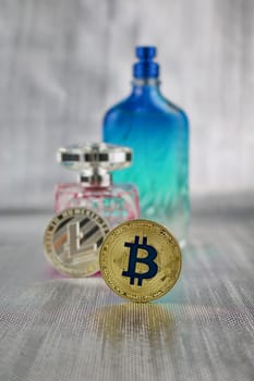 Digital currency physical silver litecoin coin and gold bitcoin near perfume
