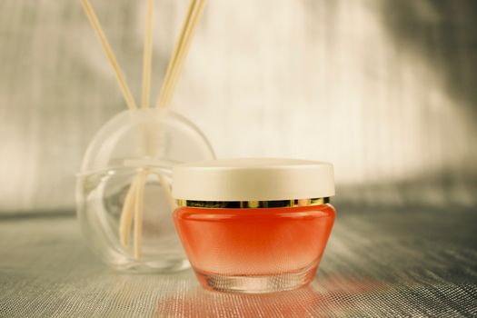 Body care concept. Skin cream in orange glass container