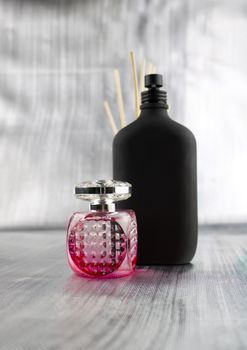 Pink and black fragrance. Perfume composition on the table.