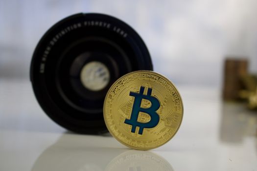 Cryptocurrency physical gold bitcoin coin - dslr lenses concept