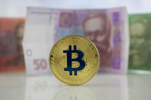 Digital currency gold bitcoin coin near Ukraine money