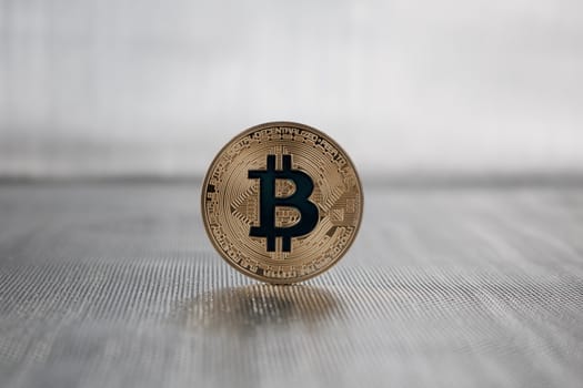 Cryptocurrency physical gold bitcoin coin with a dark blue sign
