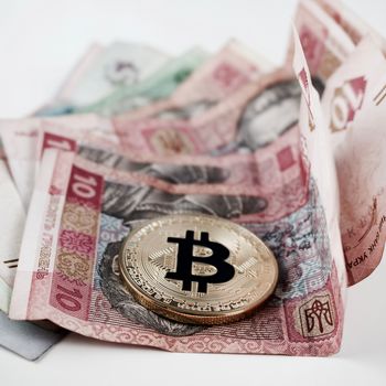 Cryptocurrency gold bitcoin coin and money from Ukraine.