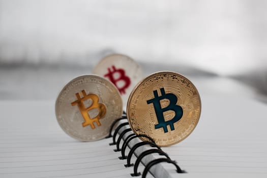 Digital currency physical silver and gold colored bitcoin coins.