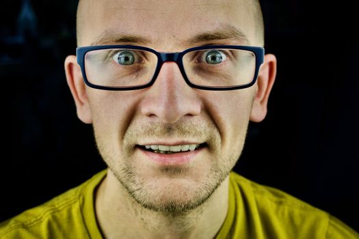 Young white man in blue glasses and yellow tshirt