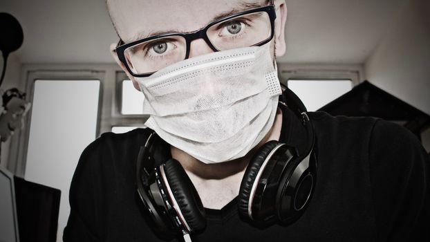 Young doctor in mask with a headphones.