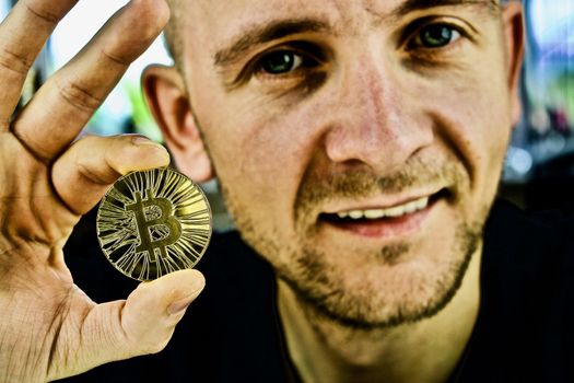 Cryptocurrency gold bitcoin coin in man hand