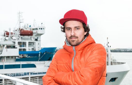 Portrait of a young successful man on the background sea landscape.