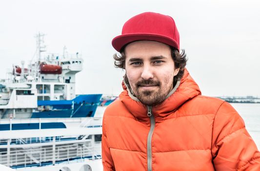 Portrait of a young successful man on the background sea landscape.