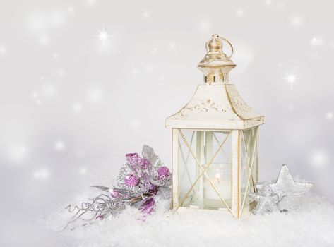 Christmas card with a burning vintage lantern, white Christmas decorations and falling snow